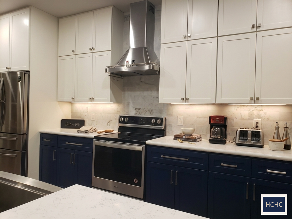 Smart design kitchen with white cabinets and blue island